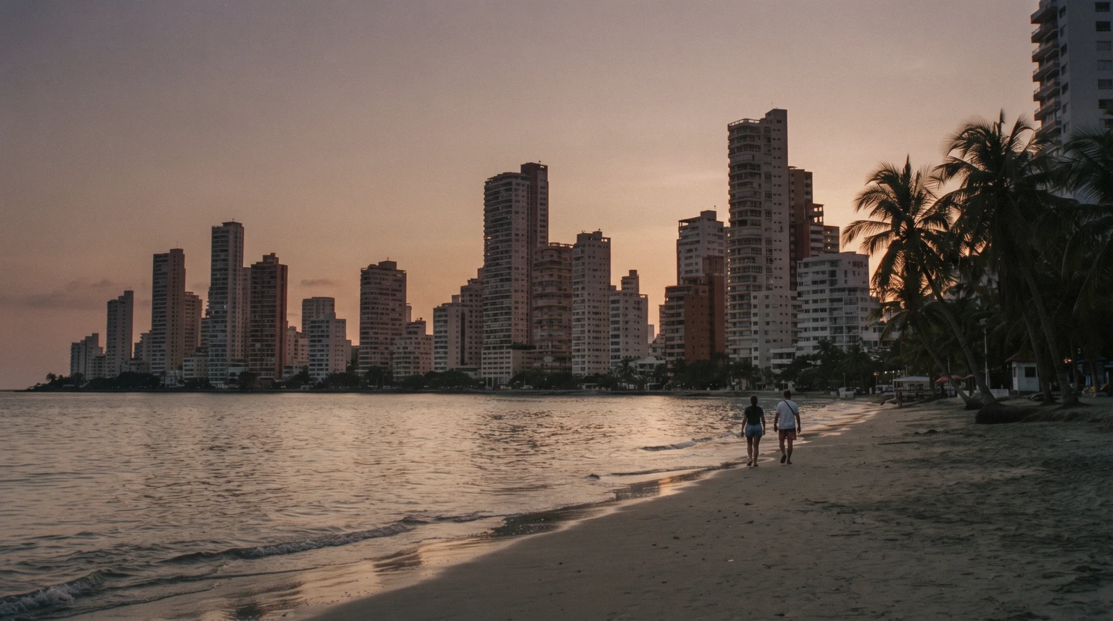 High-rise hotel towers behind the grey-gold sand of Bocagrande beach in Cartagena, Colombia