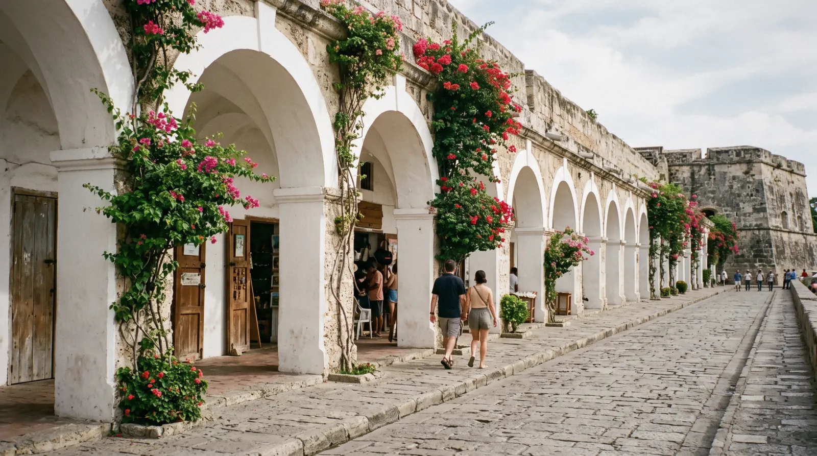 The yellow arcaded facade of Las Bóvedas souvenir arcade built into Cartagena's city walls