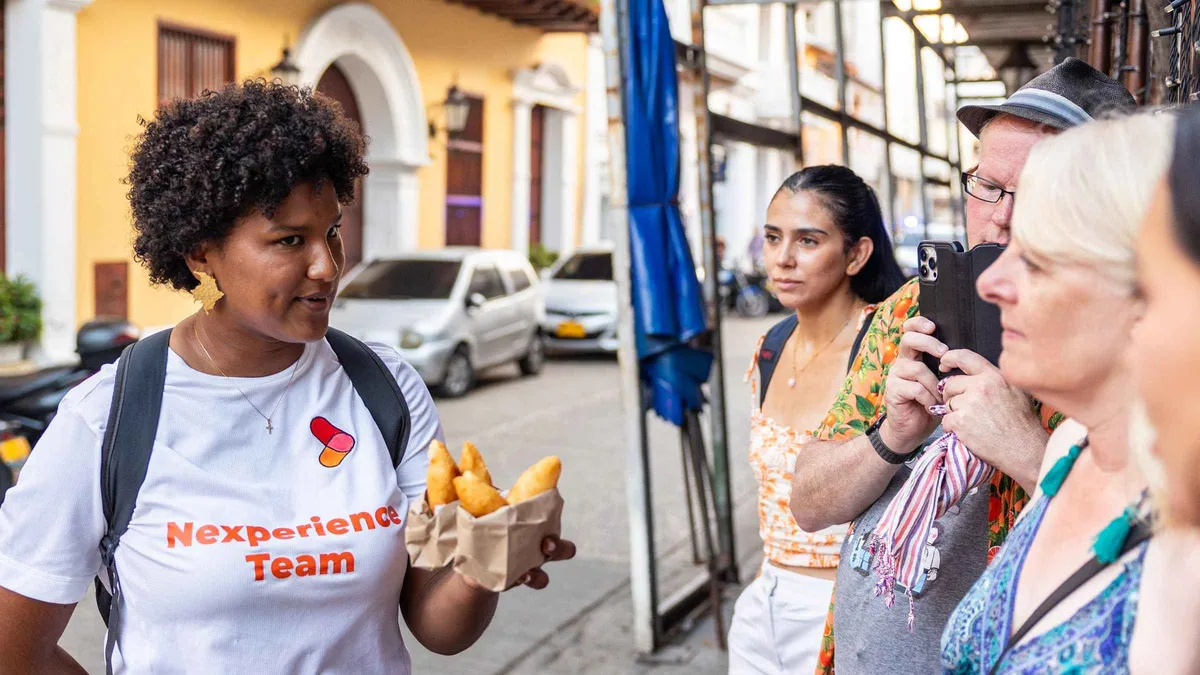 A street vendor preparing arepas on a guided street food tasting tour through Cartagena's Walled City, Colombia