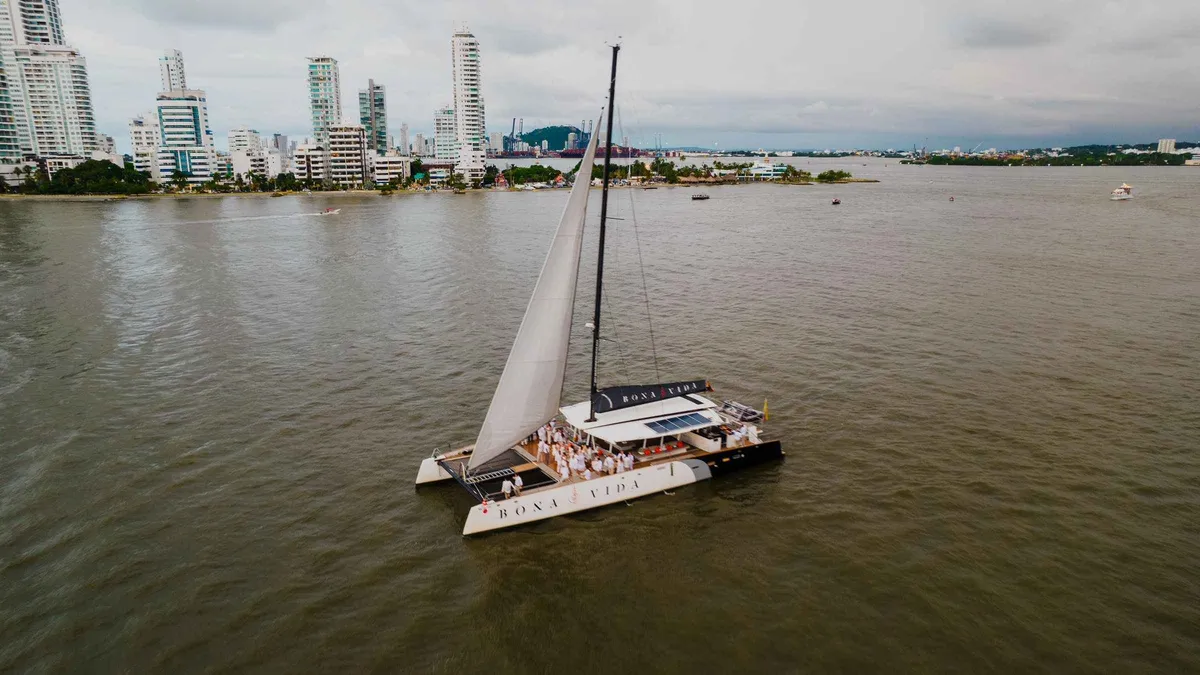 A catamaran sailing past Cartagena's skyline at sunset on a bay cruise from the Bodeguita dock, Colombia