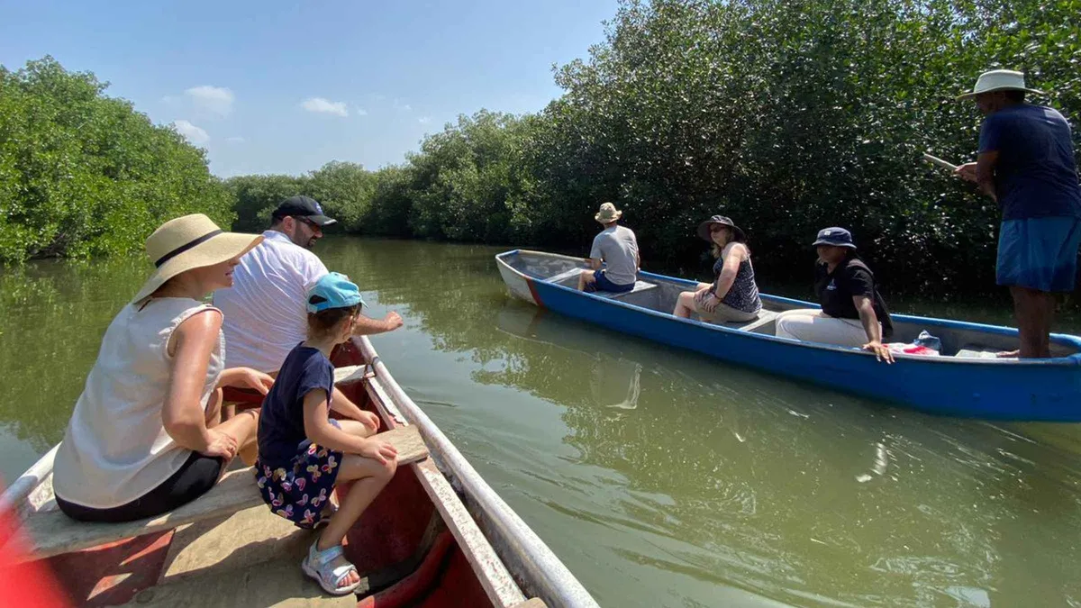 A local fisherman guiding a canoe through mangrove channels in La Boquilla near Cartagena, Colombia