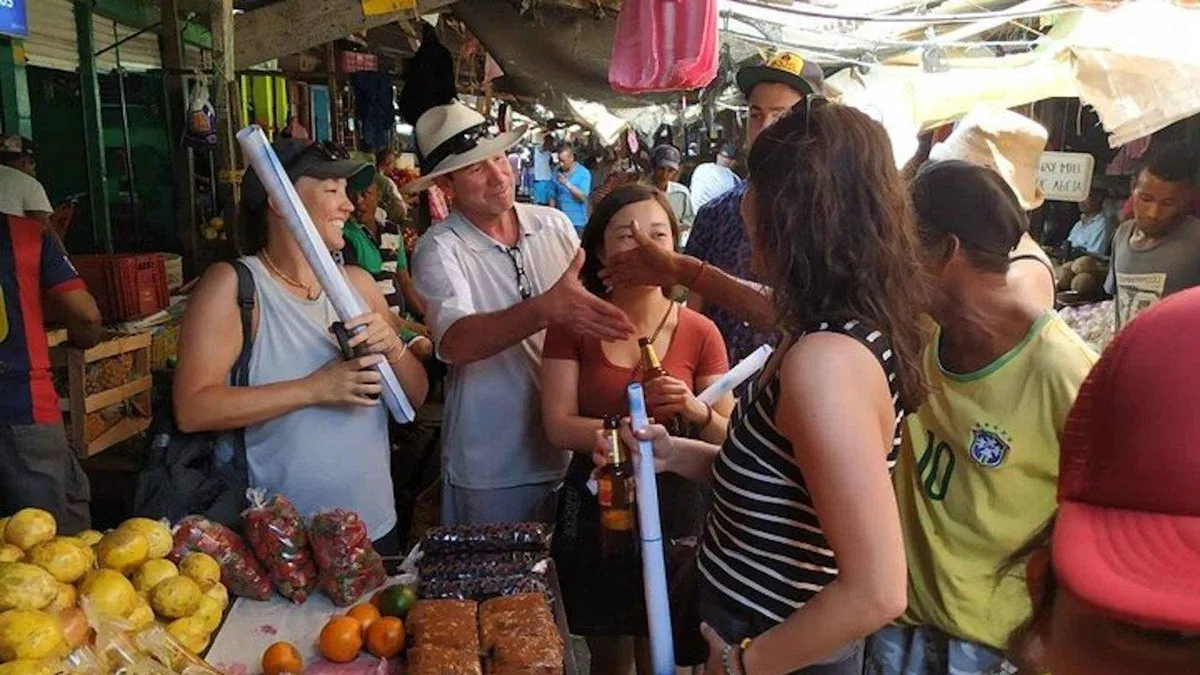 Vendors selling tropical fruit at the crowded Bazurto public market on a local food tour in Cartagena, Colombia