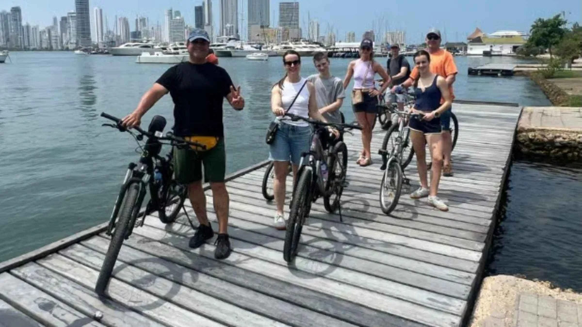 Cyclists riding through Getsemani's streets on a bike tour with a Bazurto Market lunch stop in Cartagena, Colombia