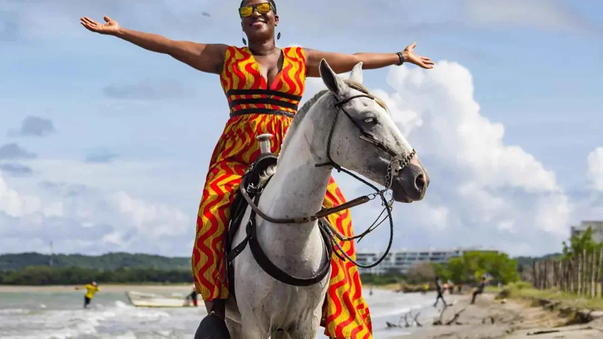 A traveler on a guided horseback ride along the beach at Manzanillo del Mar near Cartagena, Colombia